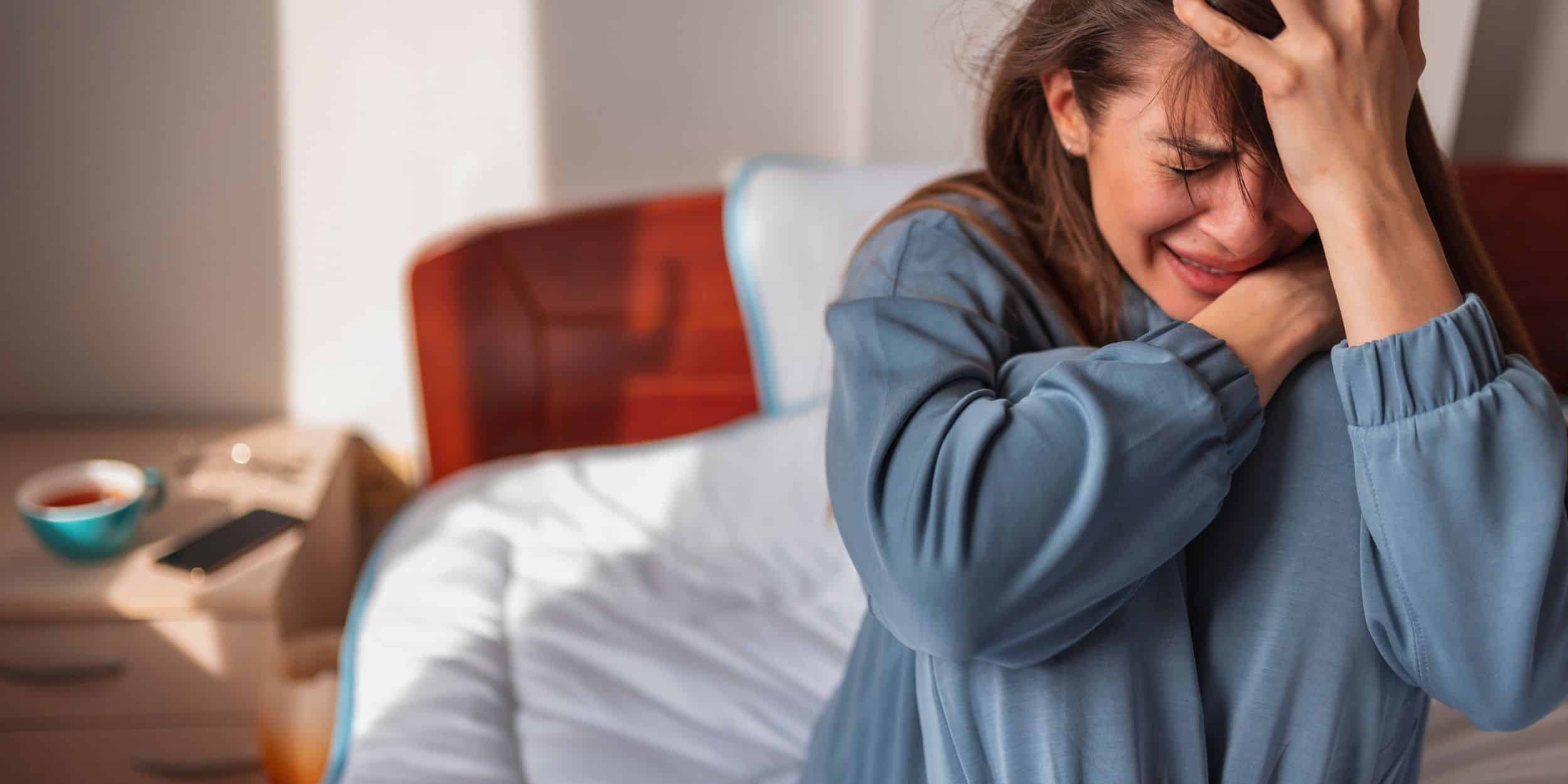 a woman laughing on a bed