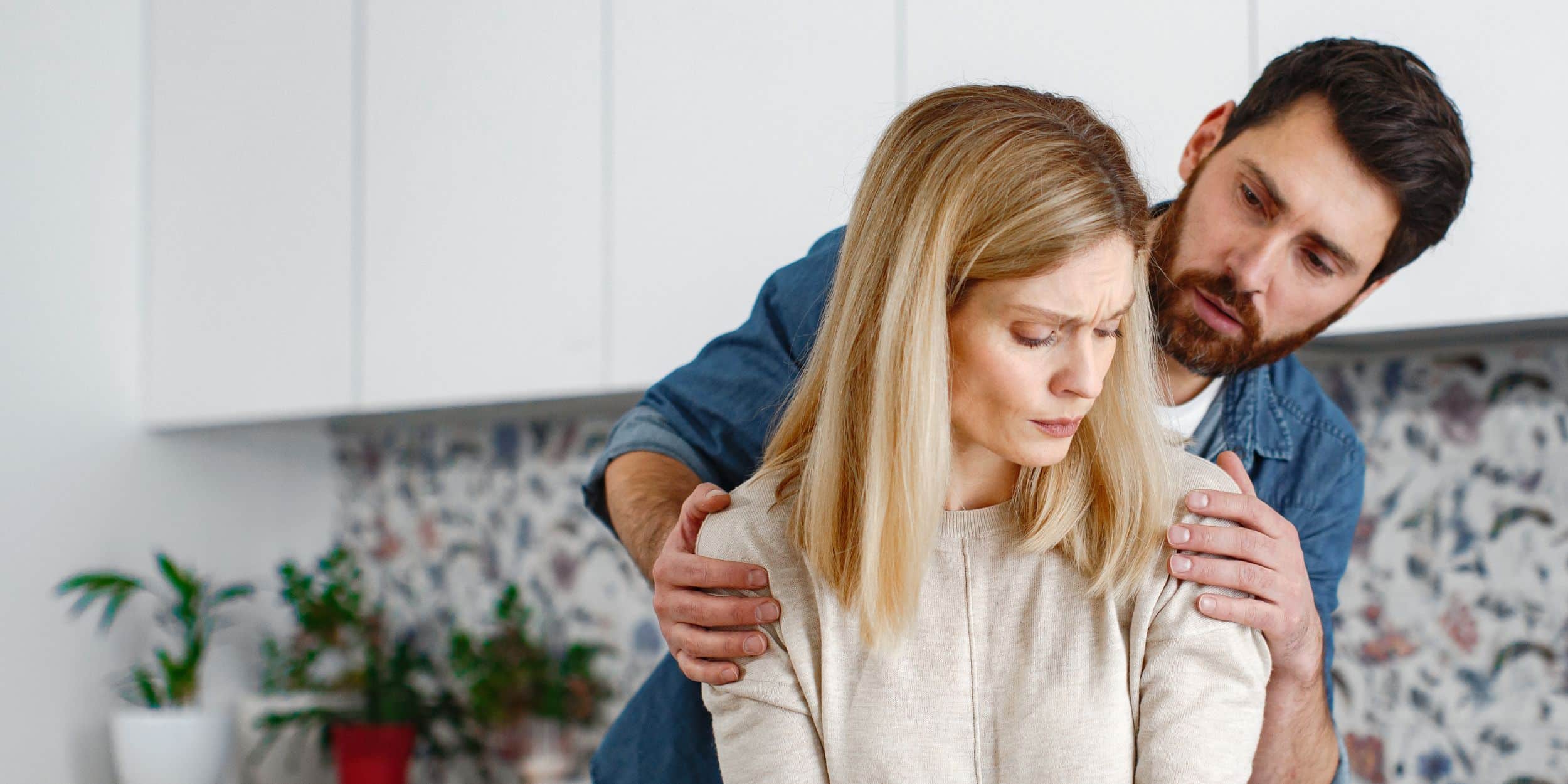 a man holding a woman's shoulder